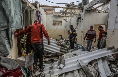 Palestinians inspect the damaged building following the Israeli attack on the Rafah, Gaza on February 25, 2024.