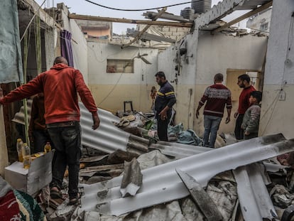 Palestinians inspect the damaged building following the Israeli attack on the Rafah, Gaza on February 25, 2024.
