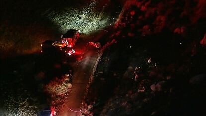 This aerial image taken from video provided by ABC7 Los Angeles shows the scene of a firefighting helicopter crash, with emergency vehicles at the base of a mountain and the area blocked off with police tape, in Cabazon, Calif., Sunday, Aug. 6, 2023.