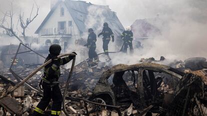 Emergency workers extinguish fire in the debris of a private house that was destroyed in a Russian rocket strike in Markhalivka, Kyiv region, on Sunday. 


