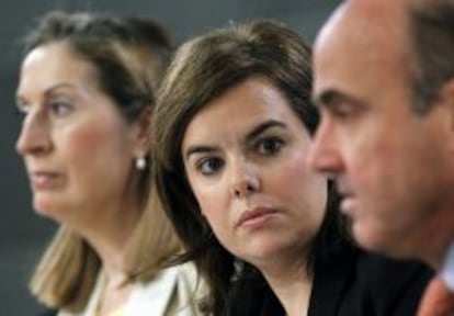 La ministra de Fomento, Ana Pastor, la vicepresidenta Soraya Sáenz de Santamaría y el ministro de Economía, Luis de Guindos, en la rueda de prensa posterior al Consejo de Ministros.