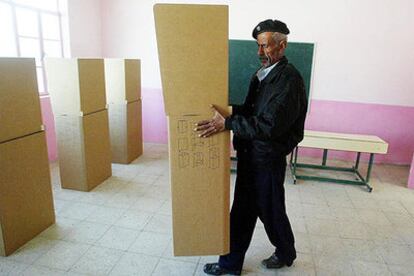 Un policía prepara las urnas de un colegio electoral que abrirá hoy sus puertas en Irak.