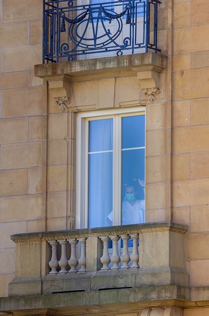 Un medico se asoma a la ventana del hotel María Cristina de San Sebastián.