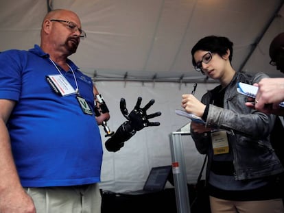 A man demonstrates his robotics arm at the DARPA open day.