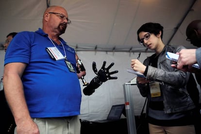 A man demonstrates his robotics arm at the DARPA open day.