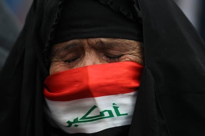 Una anciana con el rostro cubierto con una bandera nacional llora durante una protesta en la plaza Tahrir de Bagdad (Irak), el 10 de enero.