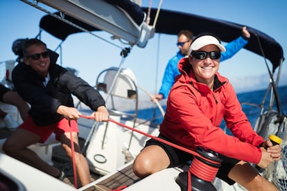 Attractive strong woman sailing with her boat