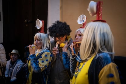 Un turista trata de hacer sonar el tradicional pito de caña, del Carnaval de Cádiz, por el que no hay que soplar, sino solo emitir un sonido.