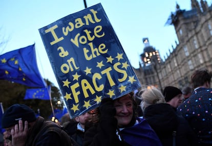 An anti-Brexit protester holds up a sign outside the Houses of Parliament in London.