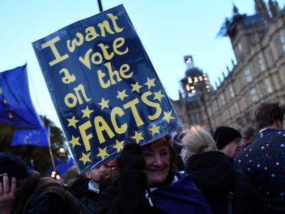 An anti-Brexit protester holds up a sign outside the Houses of Parliament in London.