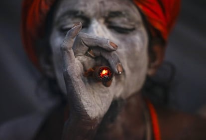Un sadhu fuma marihuana en una pipa de arcilla en el templo Pashupati en Katmandú (Nepal).