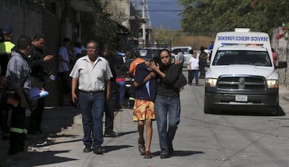 Residents of Temixco, Morelos state, comfort one another following the shooting death of their mayor.