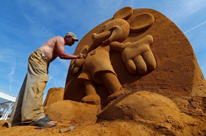 El tallador ruso Konstantin Kuzyarin trabaja en su escultura de Mickey Mouse.