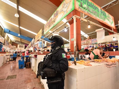 Un policía resguarda una pollería en Chilpancingo, Guerrero, luego del asesinato de ocho comerciantes de pollo en junio de este año.