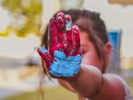 Una niña muestra su mano pintada.