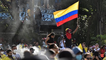 Un manifestante sostiene la bandera de Colombia durante una protesta contra el gobierno de Iván Duque, en Cali