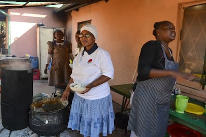 En el centro, de blanco, Seipati Mmekwa la mujer del obispo que ha montado el comedor social.