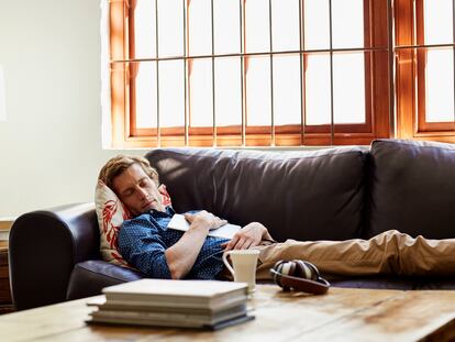 A man sleeping on the couch at home.