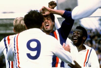 Sylvester Stallone, abrazado por sus compañeros (Pelé, a la derecha), tras parar el penalti en <i>Evasión o victoria.</i>