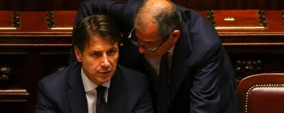 El primer ministro italiano, Giuseppe Conte, habla con el ministro de Finanzas, Giovanni Tria.