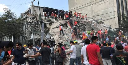 Voluntarios trabajan en las tareas de ayuda junto a un edificio derrumbado en Ciudad de México tras el terremoto que ha afectado al país.