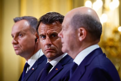 Polish President Andrzej Duda, left, French President Emmanuel Macron, center, and German Chancellor Olaf Scholz attend a joint press conference