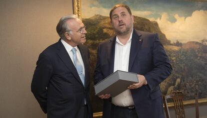 Junqueras sostiene el ejemplar de una obra de Camilo Jos&eacute; Cela que le regal&oacute; el presidente de la Fundaci&oacute;n La Caixa, Isidro Fain&eacute;.