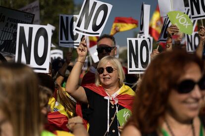 Una manifestante sostiene un cartel en contra de la amnistía. 
