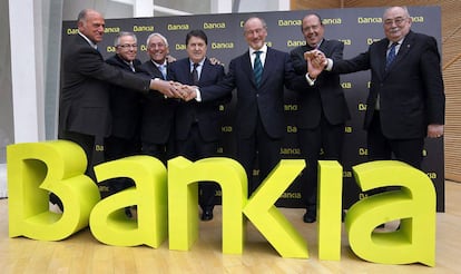 Caja Madrid Chairman Rodrigo Rato (center) in March 2011 with the chiefs of the six other savings banks which made up Bankia. Just over a year after it would be nationalized.