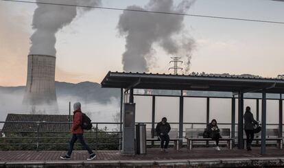 Unos viajeros esperan un tren en la estación de Las Segadas, junto a la central térmica de Soto de Ribera 3, en Oviedo.