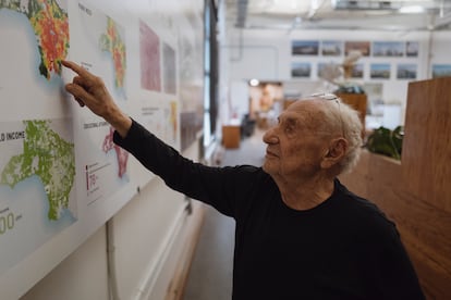 Gehry shows a map of his new project in his L.A. studio. 

