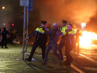 Three police officers arrest a protestor in Dublin, on Thursday, November 23, 2023.