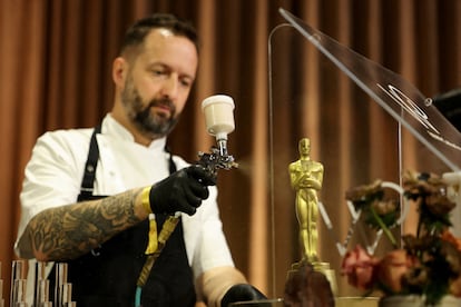 Garry Larduinat, jefe de pastelería de Wolfgang Puck, pinta un Oscar de chocolate.