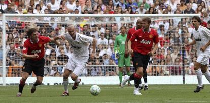 Zinedine Zidane se lleva el balón ante los jugadores del Manchester United Jesper Blomqvist y Teddy Sheringham.