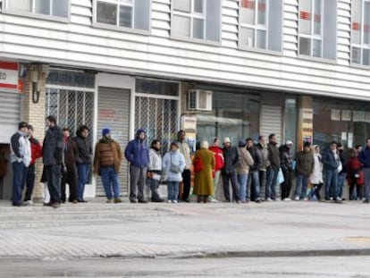 People line up outside an employment office.