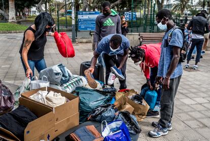 Senegalese migrants receiving clothes donated to the Somos Red support group in Gran Canaria.