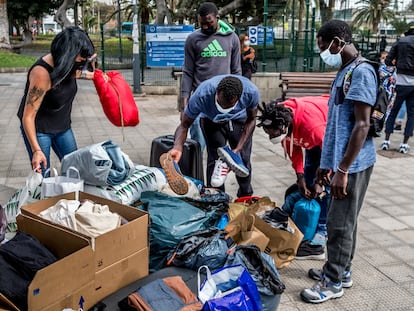 Senegalese migrants receiving clothes donated to the Somos Red support group in Gran Canaria.