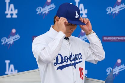 Newly-signed Los Angeles Dodgers baseball player Yoshinobu Yamamoto wears his jersey during an introductory press conference at Dodger Stadium in Los Angeles, California, on Dec. 27, 2023.