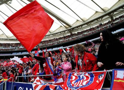 Atlético fans wave flags during the match.