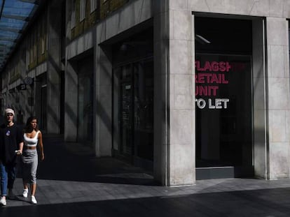 Una pareja pasea por el vacío mercado de Spitalfields en Londres.