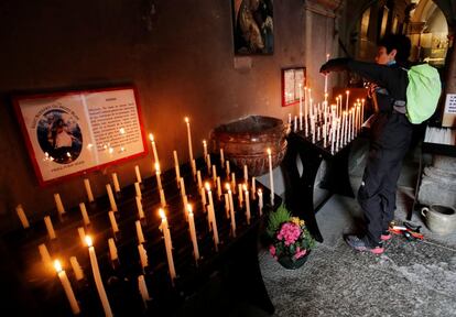 Un corredor enciende unas velas en la iglesia de Saint Michel de Chamonix antes de la prueba, el 31 de agosto.