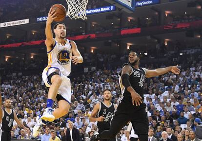 Klay Thompson a punto de anotar tras superar a LaMarcus Aldridge.