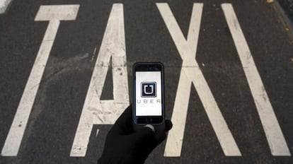 An Uber user next to a taxi lane in Madrid in December 2014.