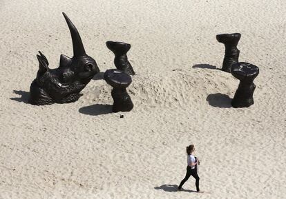 Obra titulada 'Rinoceronte entrerrado', de los artistas Gillie y Marc Schattner, que forma parte de la exposición anual al aire libre conocida como Escultura por la playa, cerca del arenal australiano de Bondi.