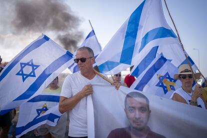 Relatives, friends and supporters of Israeli hostages still in Gaza take part in a protest on a road in Kibbutz Yakum, north of Tel Aviv, on Monday.