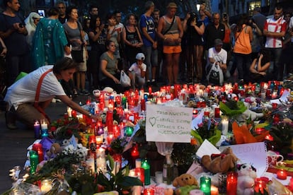 Pessoas deixam flores e velas em homenagens às vítimas em Las Ramblas.