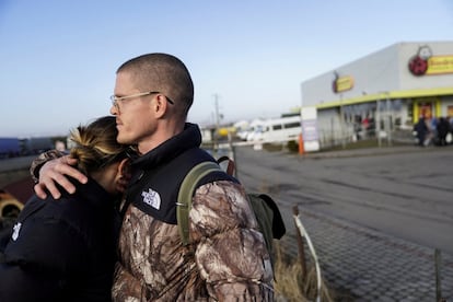 Una pareja estadounidense se abraza en Medyka (Polonia) después de cruzar la frontera y huir de la violencia en Ucrania.