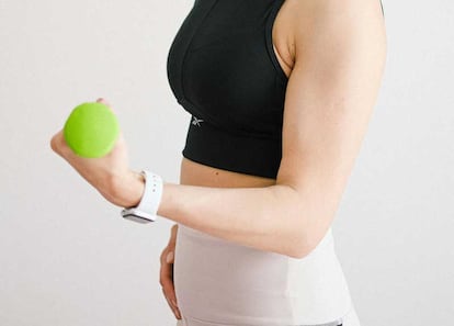 Chica con ropa deportiva utilizando un Apple Watch