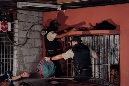 Dos policías buscan armas y drogas durante el toque de queda impuesto en Ecuador en el barrio Flor de Bastión de Guayaquil.  