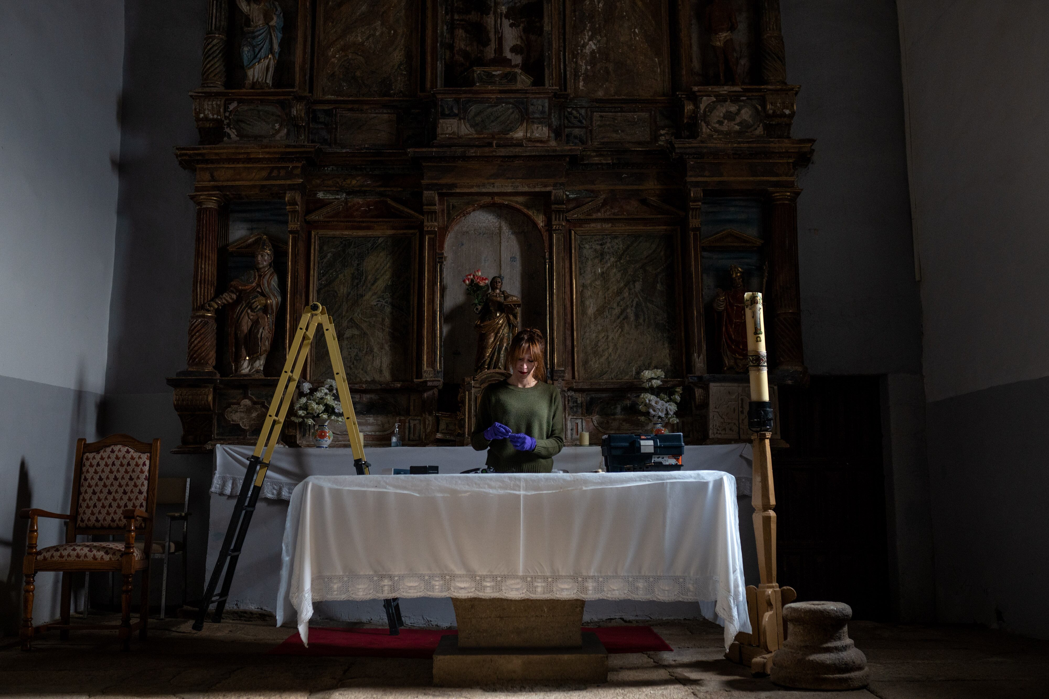 Aurora Galisteo, autora de la tesis sobre los retablos de las comarcas de Alba y Aliste, prepara el material de trabajo sobre el altar de la iglesia de Tolilla.